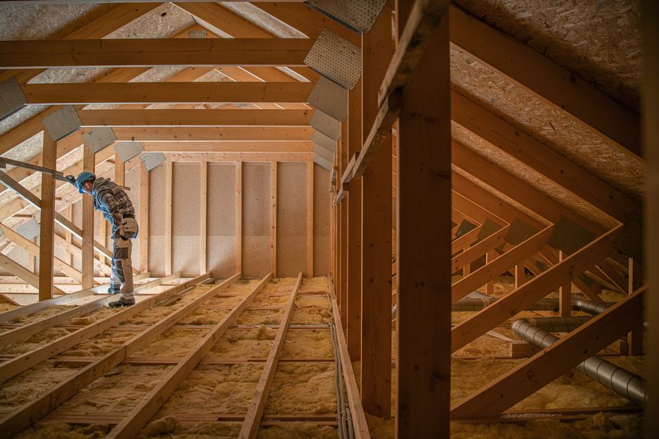 Roof decking, trusses, and insulation work during a structural roof rebuild in Houston