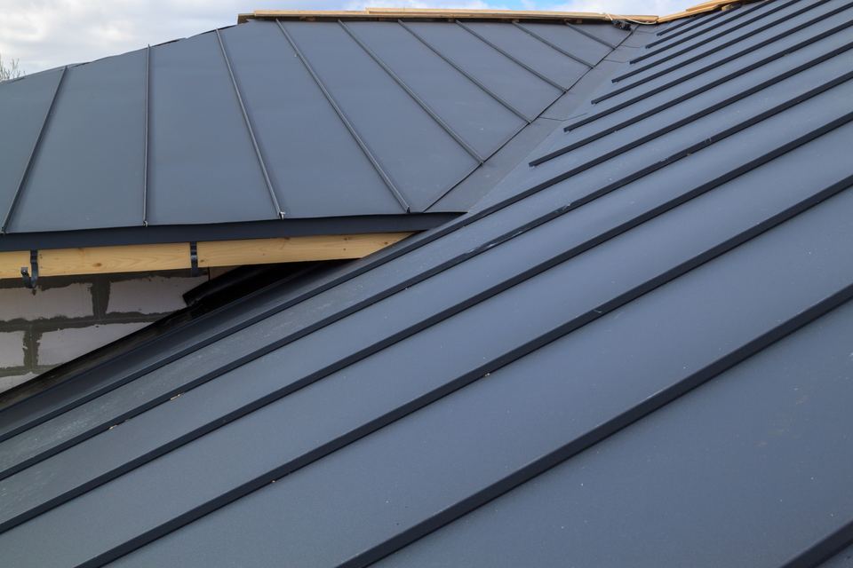 Close-up of a standing-seam metal roof installation by Houston roofing contractor Roof Roof LLC